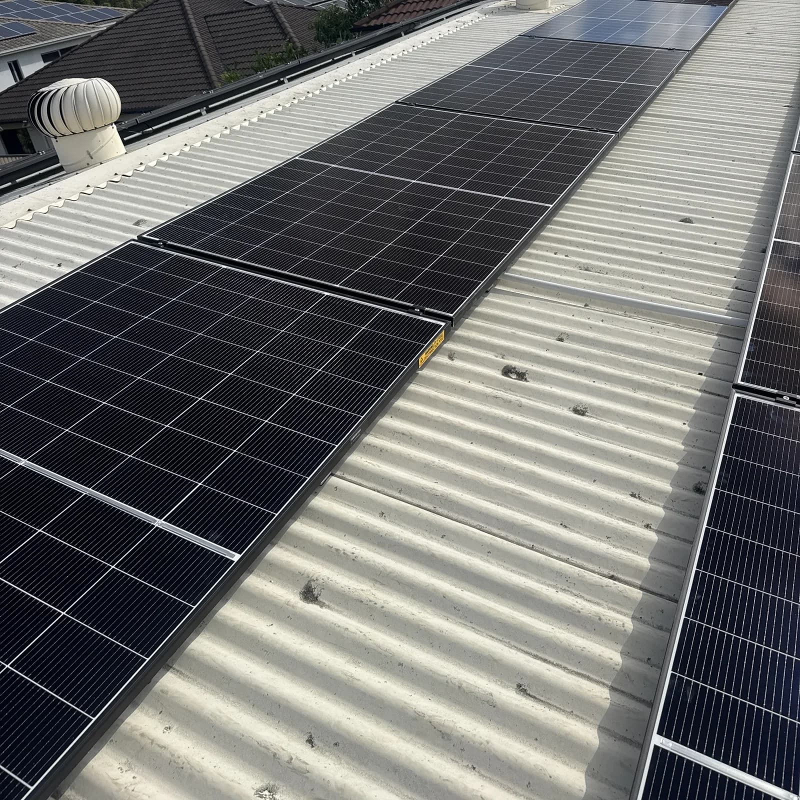 Full roof solar array installed by Nuvolt Electrical on a suburban Queensland home