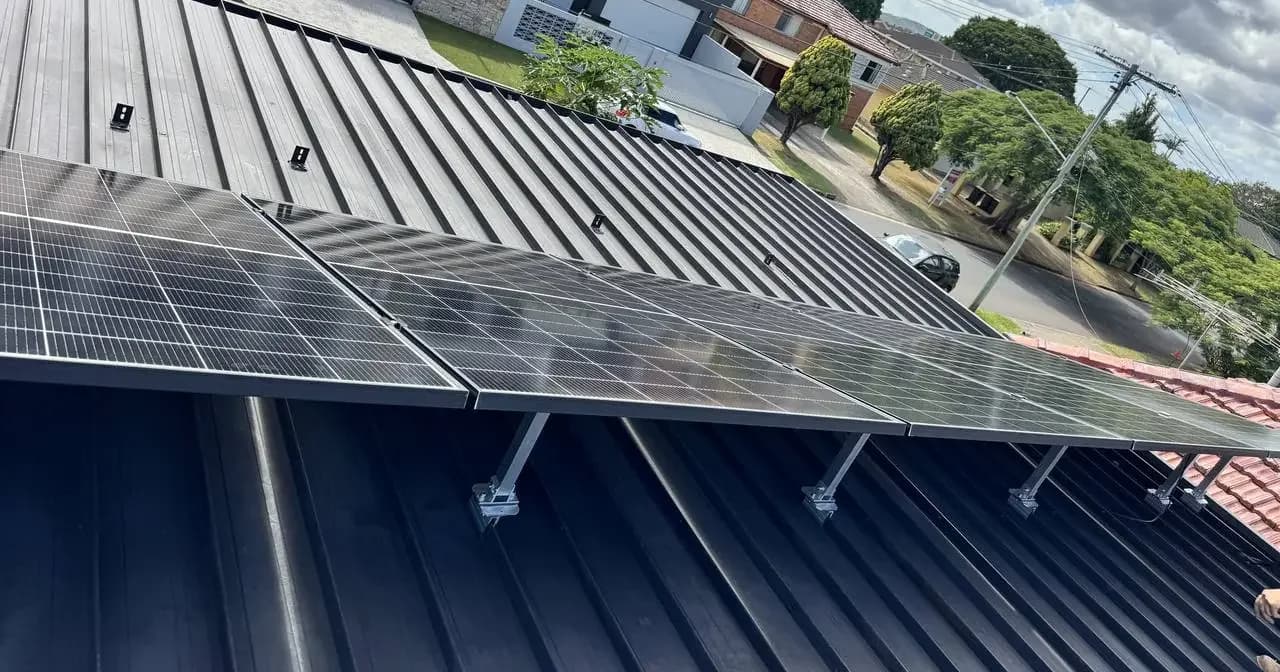 North facing tilt frame solar array installed by Nuvolt Electrical on a low pitch roof in Robertson, Brisbane