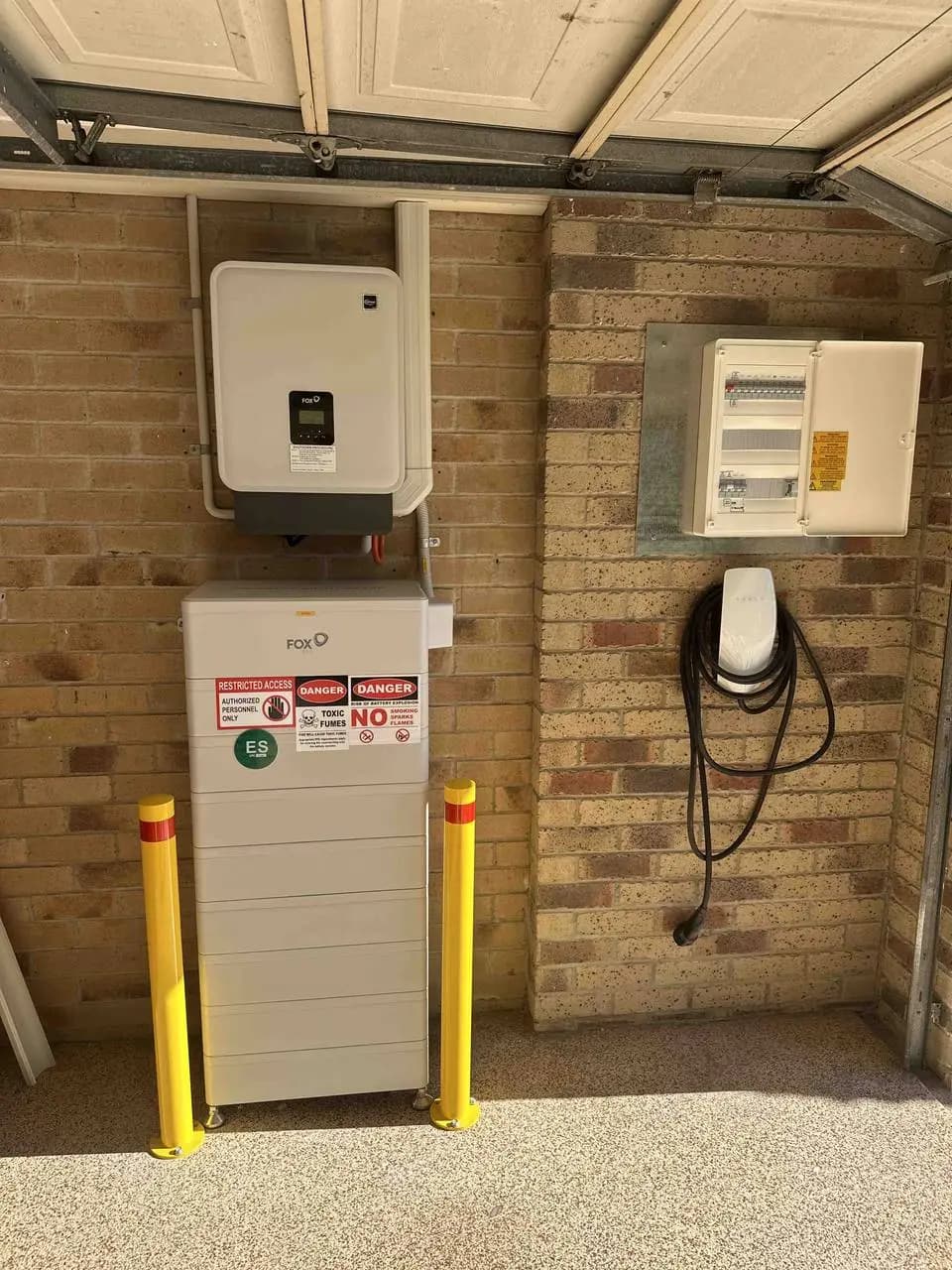 Fox ESS hybrid inverter, home battery and an EV wall charger in a residential garage
