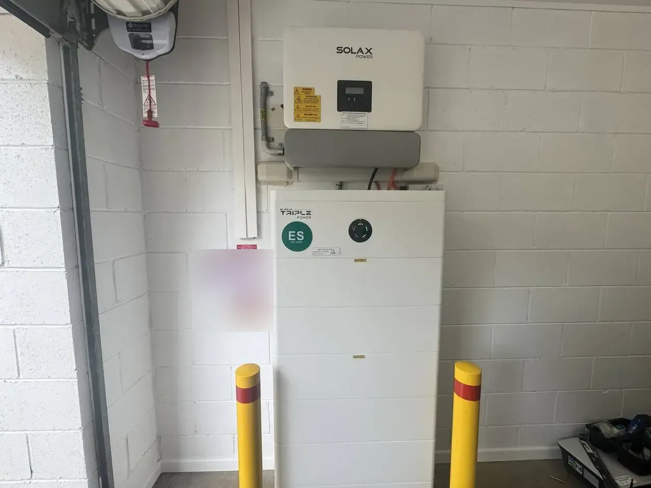SolaX Triple Power home battery and hybrid inverter installed by Nuvolt Electrical in a Toogoom garage on the Fraser Coast