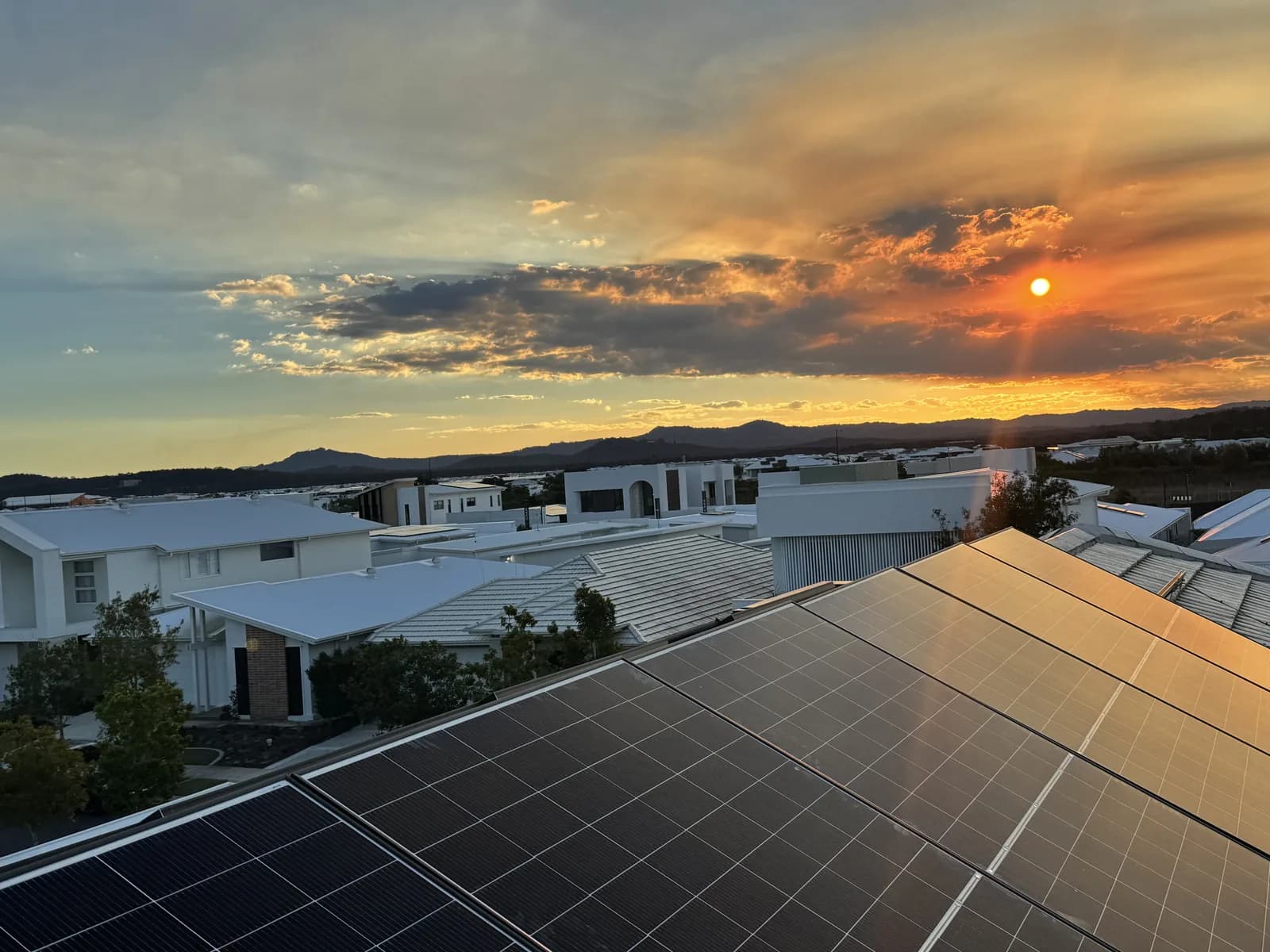 Rooftop solar panels at sunset on a Sunshine Coast home, installed by Nuvolt Electrical