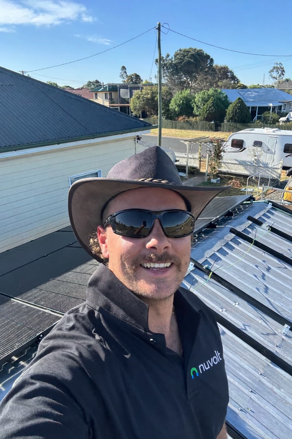 Nuvolt electrician fitting rooftop solar panels on a Sunshine Coast home