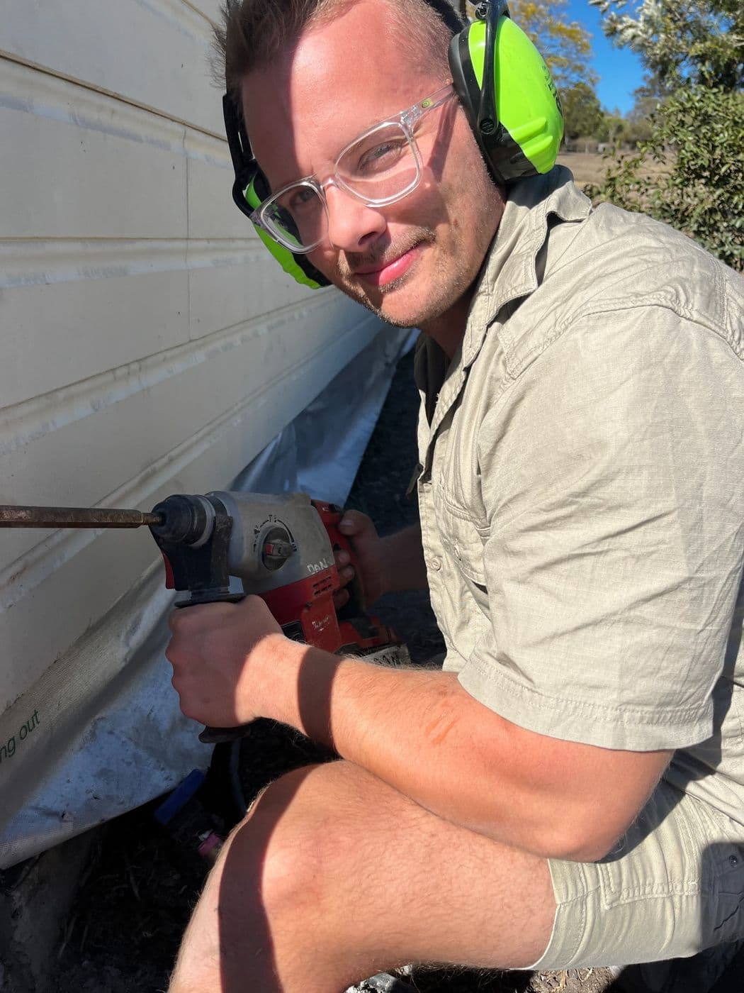 Licensed Nuvolt electrician drilling a new cable run on site