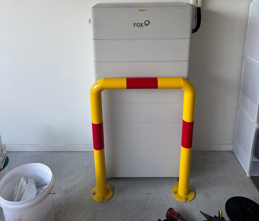 48kWh Fox ESS battery stack in a garage, bollard protected and labelled for safe isolation