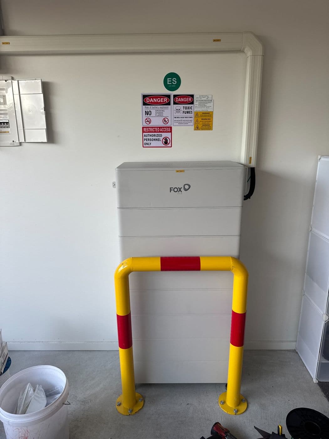48kWh Fox ESS battery stack in a garage, bollard-protected and labelled for safe isolation
