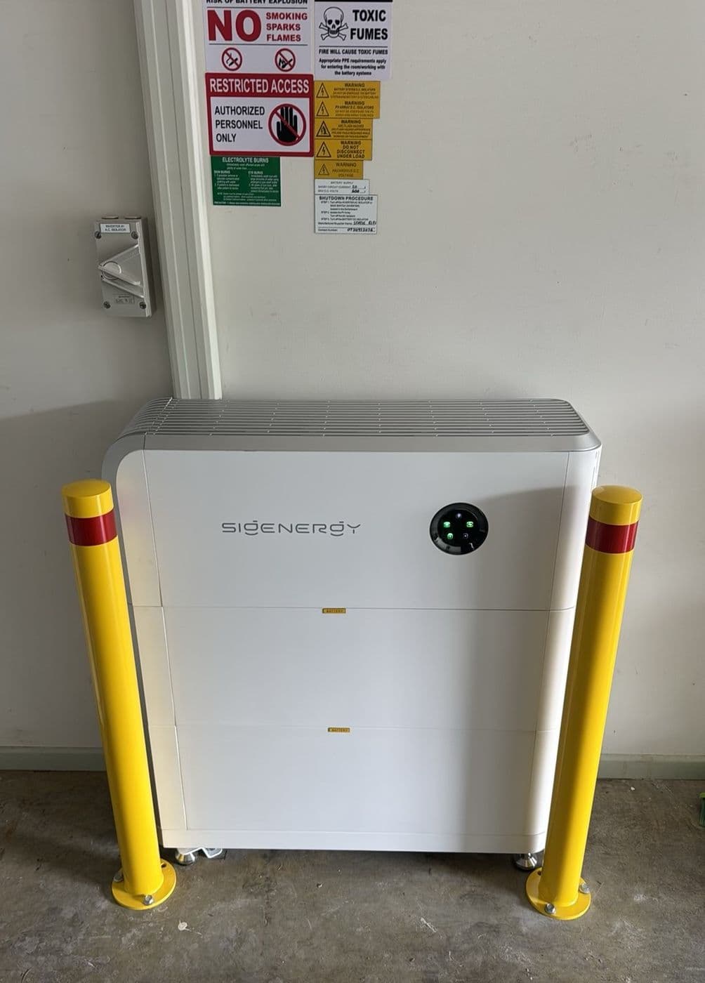 Sigenergy home battery installed and commissioned, bollard-guarded and labelled