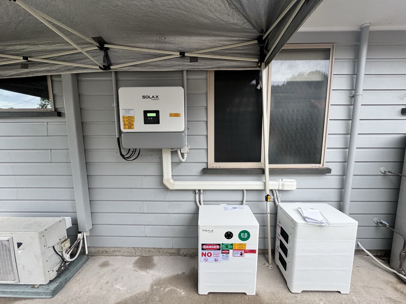 SolaX hybrid inverter and home battery installed by Nuvolt Electrical in a Coolum Beach garage on the Sunshine Coast