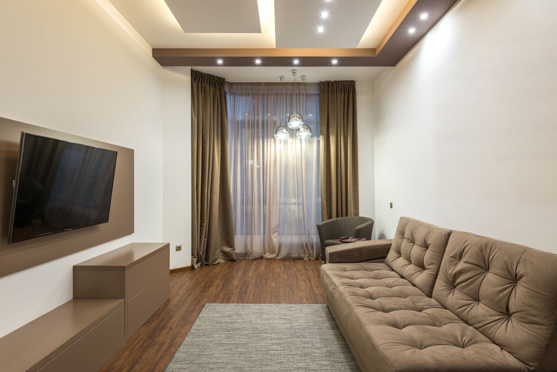 Living room ceiling with recessed LED downlights and warm feature lighting