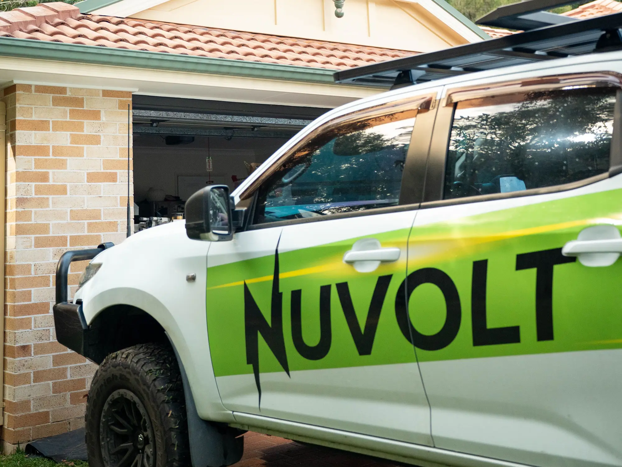 The Nuvolt ute in its new wrap, parked in the driveway of a Sunshine Coast home